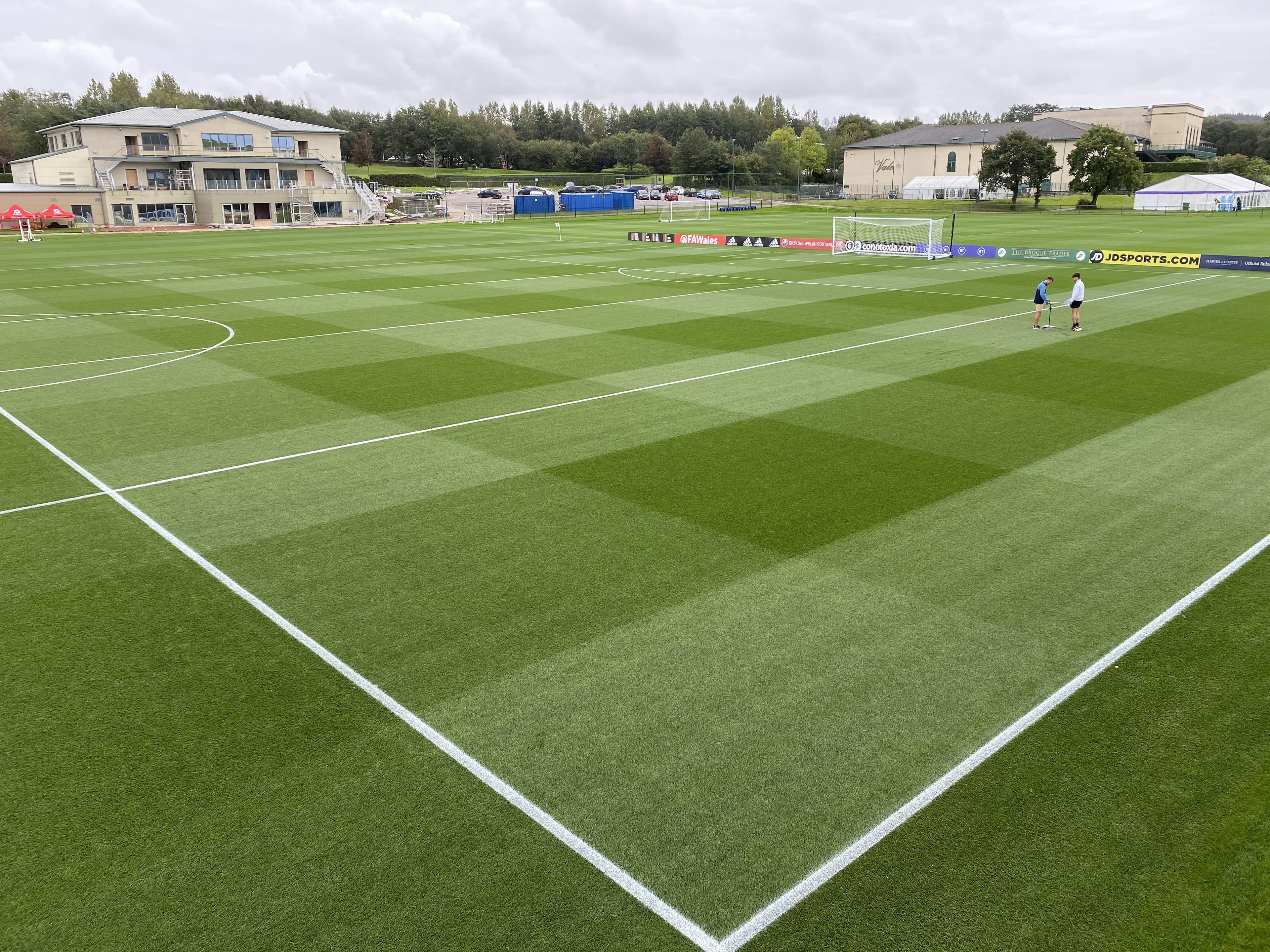 Natural-turf football training pitches beside the Vale buildings