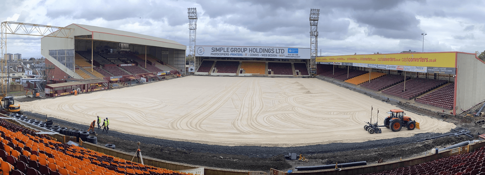 Prepared stadium pitch profile with tractor and surrounding Fir Park stands