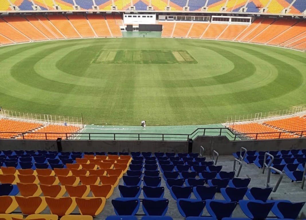 Completed cricket outfield with mowing patterns and surrounding seating